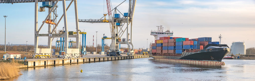 sea container flows into port for unloading harbor cranes and gantries